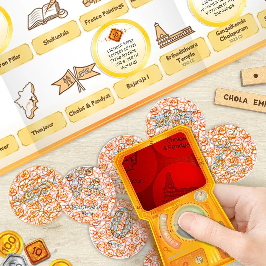 Educational game with cards and a handheld device on a wooden surface
