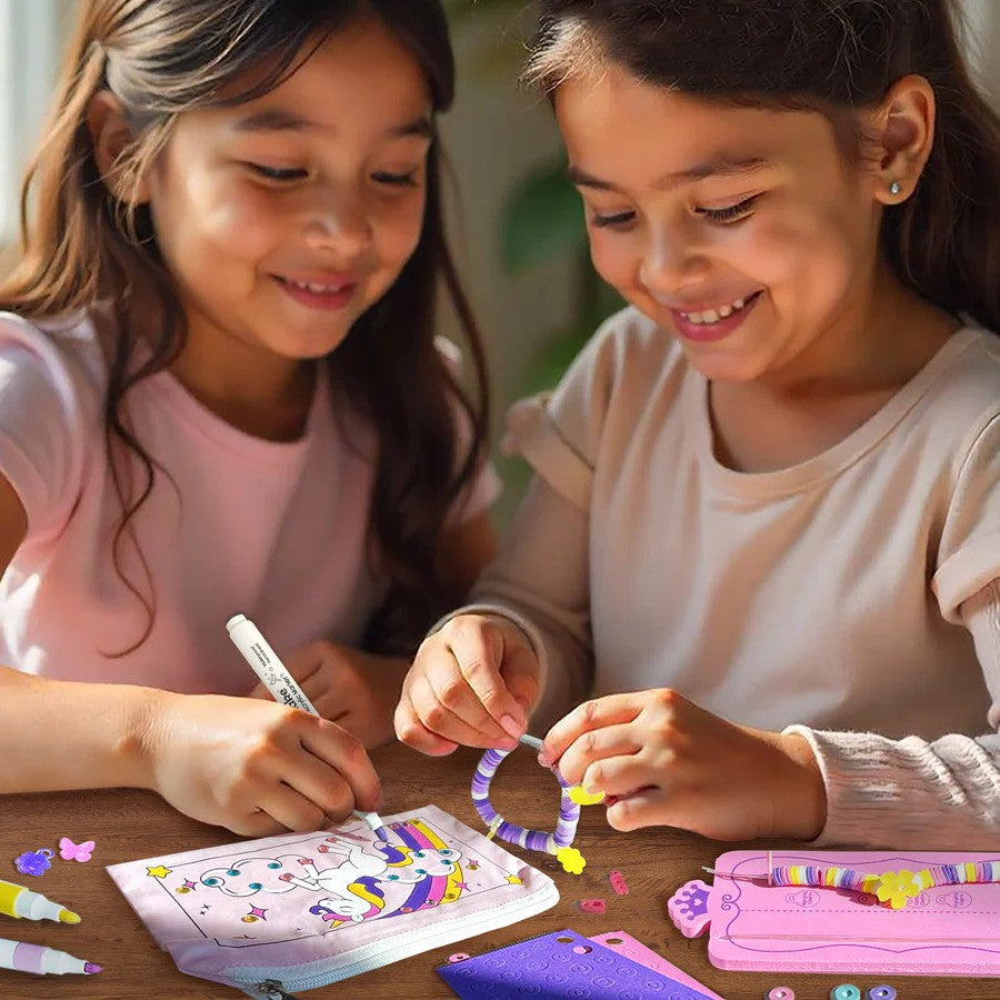Two young girls engaged in a craft activity with markers and paper.