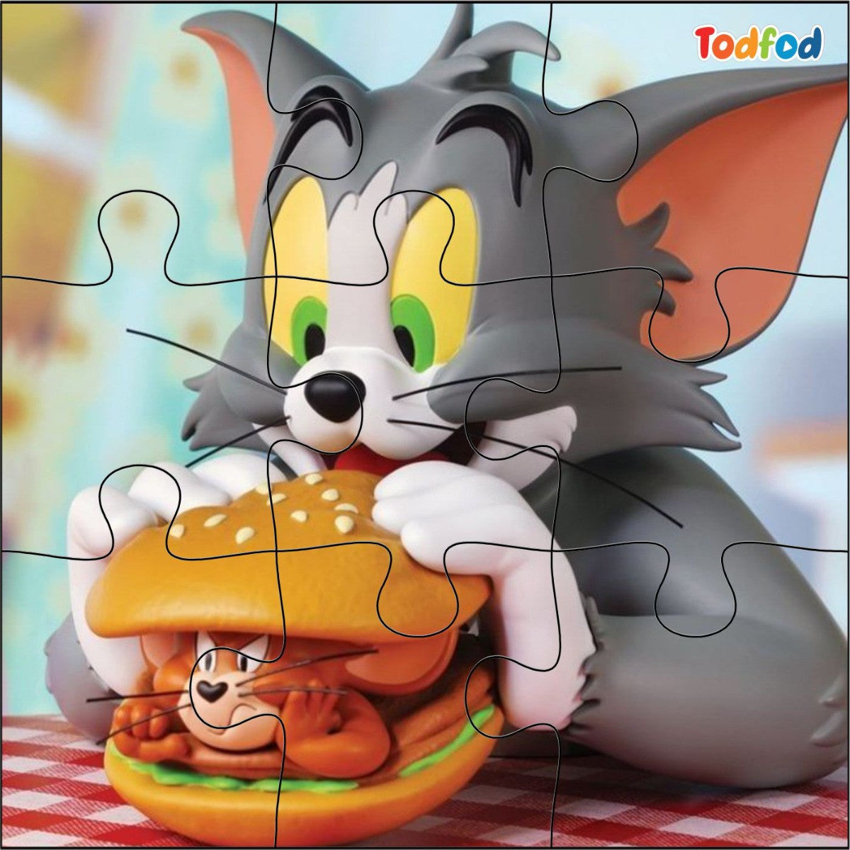 Cartoon cat character with a hamburger on a checkered tablecloth, branded 'Todfod'.