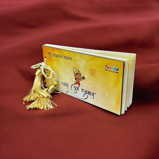 Small book with a gold tassel on a red fabric background