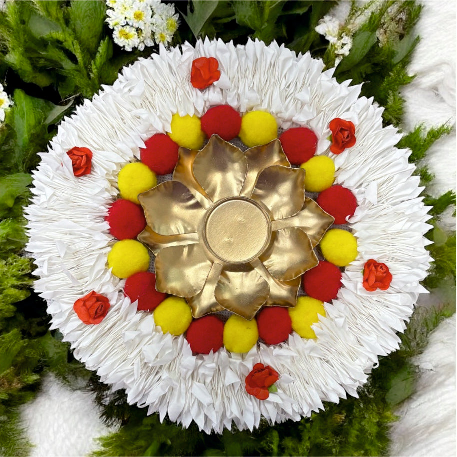 Decorative flower arrangement with a gold center on a green leaf background