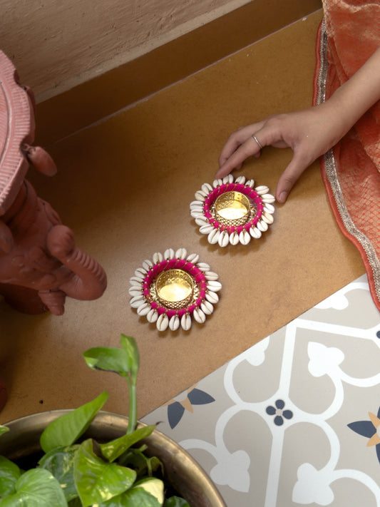 Decorative oil lamps with floral designs on a wooden surface.