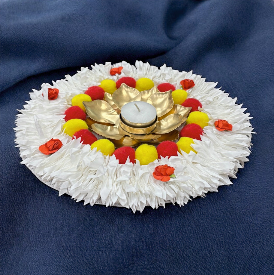 Decorative arrangement with a white base, gold center, and colorful flowers on a blue background