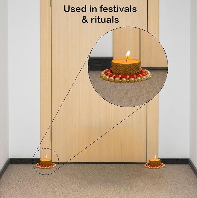 Decorative candles with pearl-like beads on a wooden door, used in festivals and rituals.