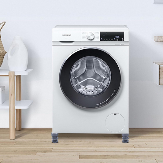 White Siemens washing machine in a laundry room with wooden floor and shelves.