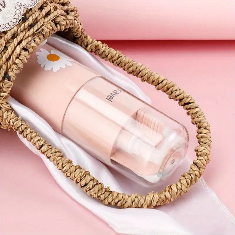 Pink cosmetic bottle with a white cap featuring a daisy design, placed on a woven mat with a pink background.