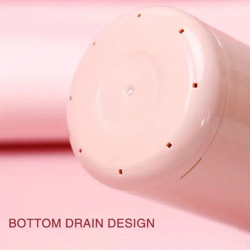 Close-up of a pink cylindrical object with 'BOTTOM DRAIN DESIGN' text on a pink background