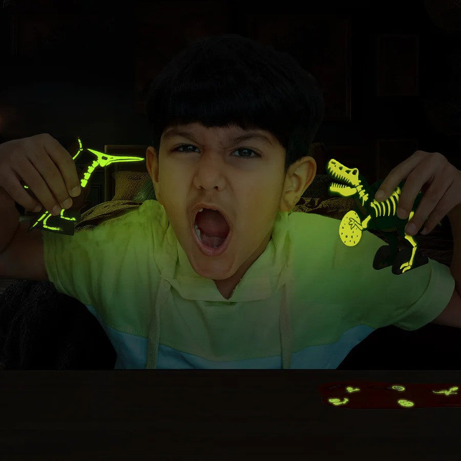 Child holding glow-in-the-dark dinosaur toys in a dark setting