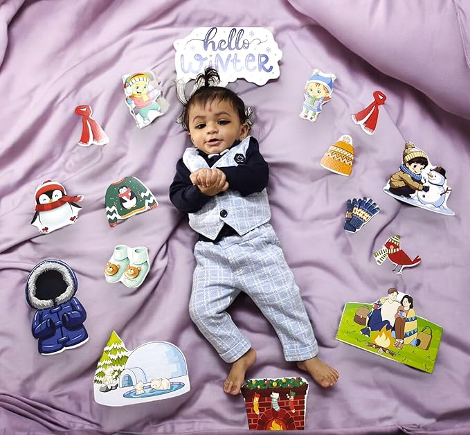Baby in a suit surrounded by winter-themed illustrations on a purple blanket