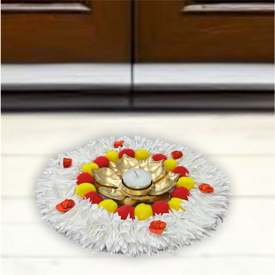 Decorative flower arrangement with a gold plate and candle on a white background
