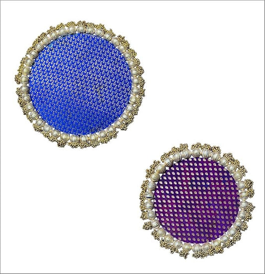Two round decorative items with blue and purple centers and pearl-like borders on a white background.