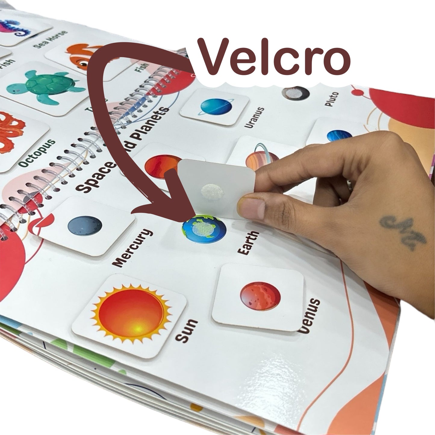 Hand interacting with educational cards featuring planets, with 'Velcro' branding visible.