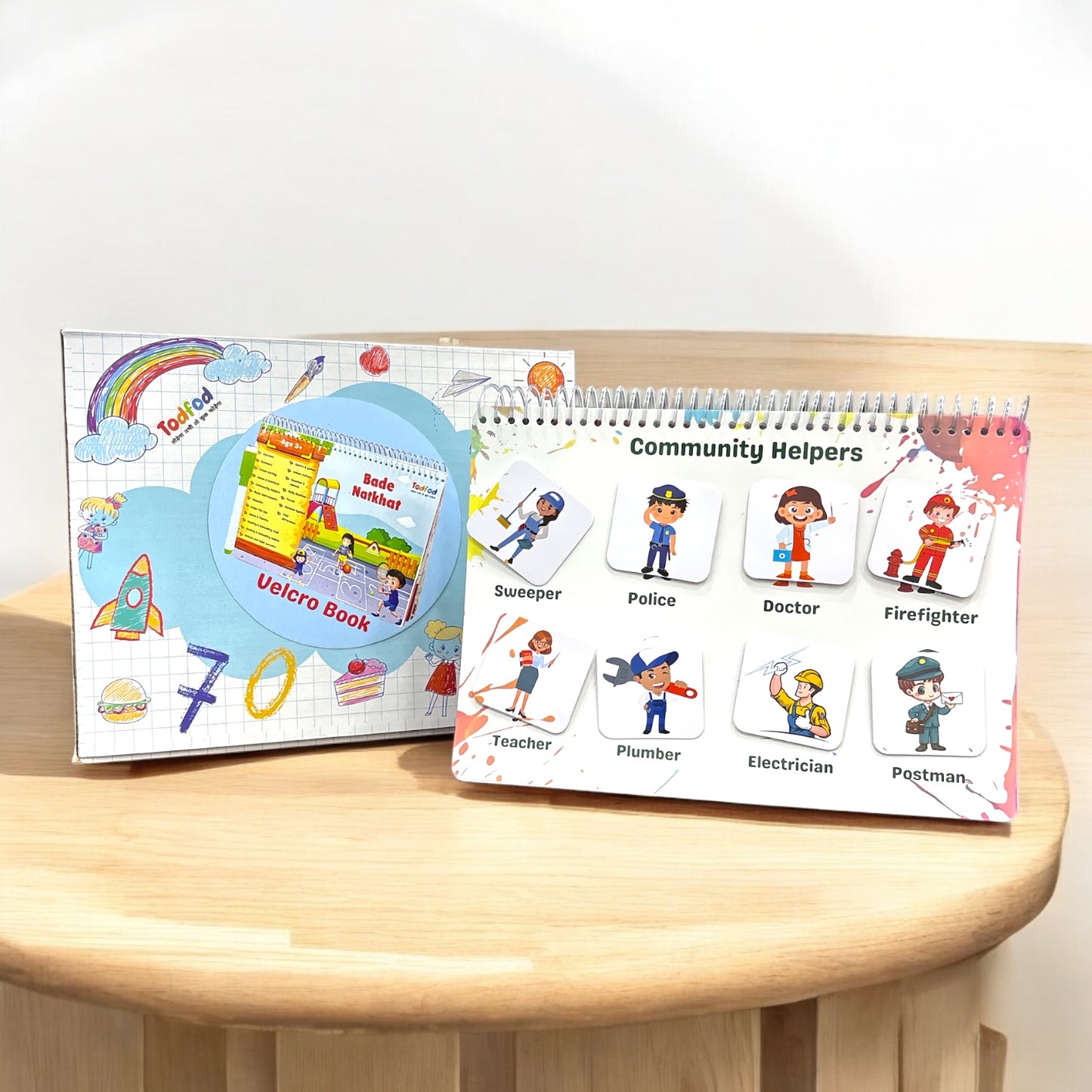 Educational book on a wooden surface with colorful illustrations of community helpers.