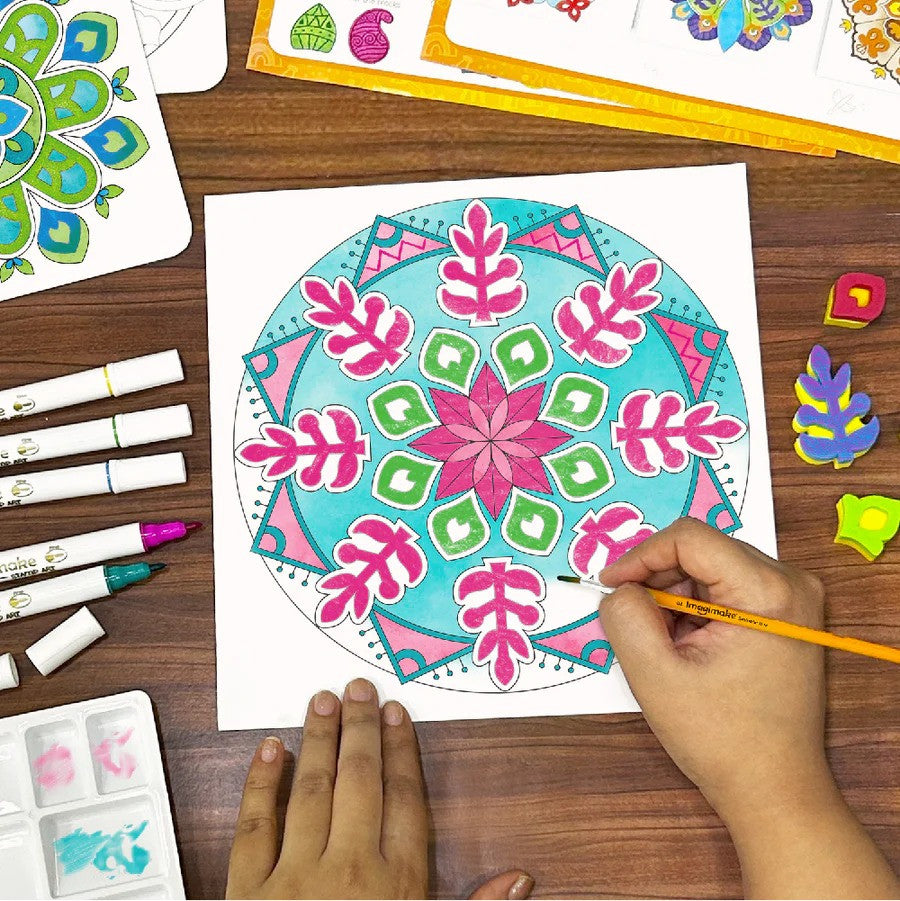 Person coloring a mandala design on paper with markers on a wooden table.