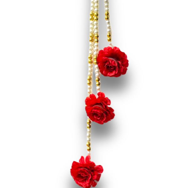 Necklace with red floral pendants and gold beads on a white background