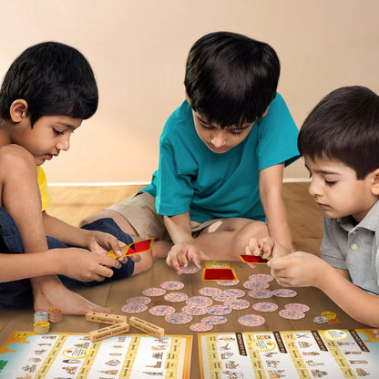 Three children playing with a board game on a wooden floor.