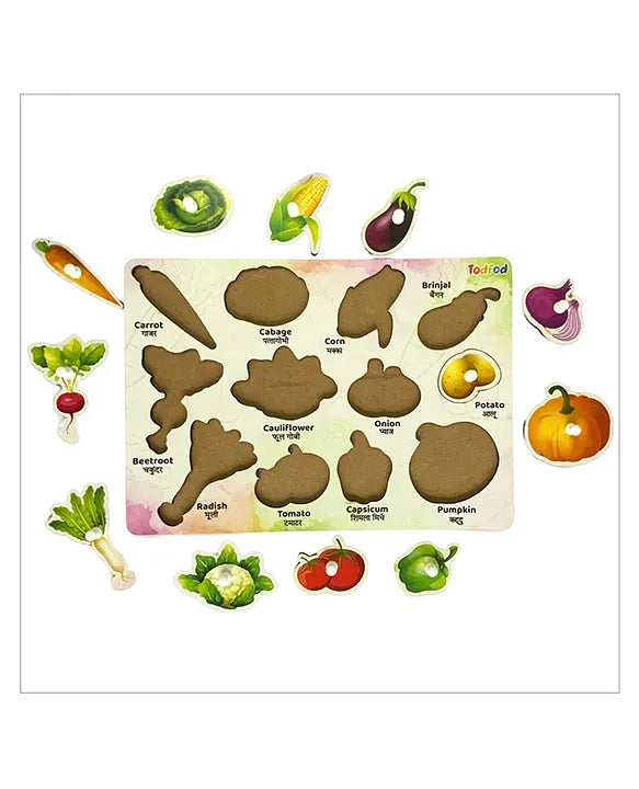colorful vegetable-shaped wooden puzzle board for kids, with labeled slots for vegetables like carrot, cabbage, corn, brinjal, potato, beetroot, cauliflower, onion, pumpkin, radish, tomato, and capsicum. The corresponding wooden pieces are placed around the board