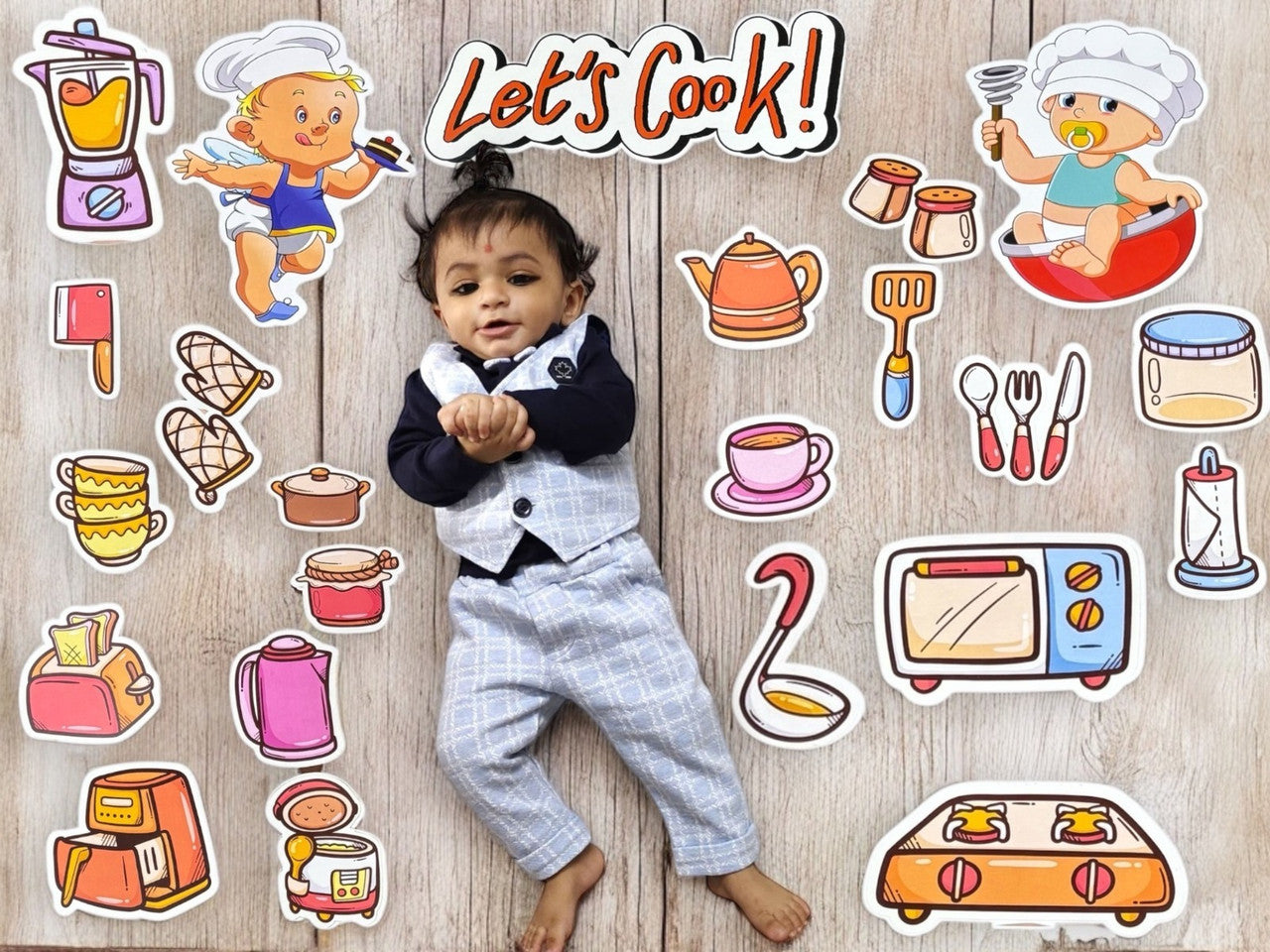 Child surrounded by cooking-themed stickers with 'Let's Cook!' text on a wooden background