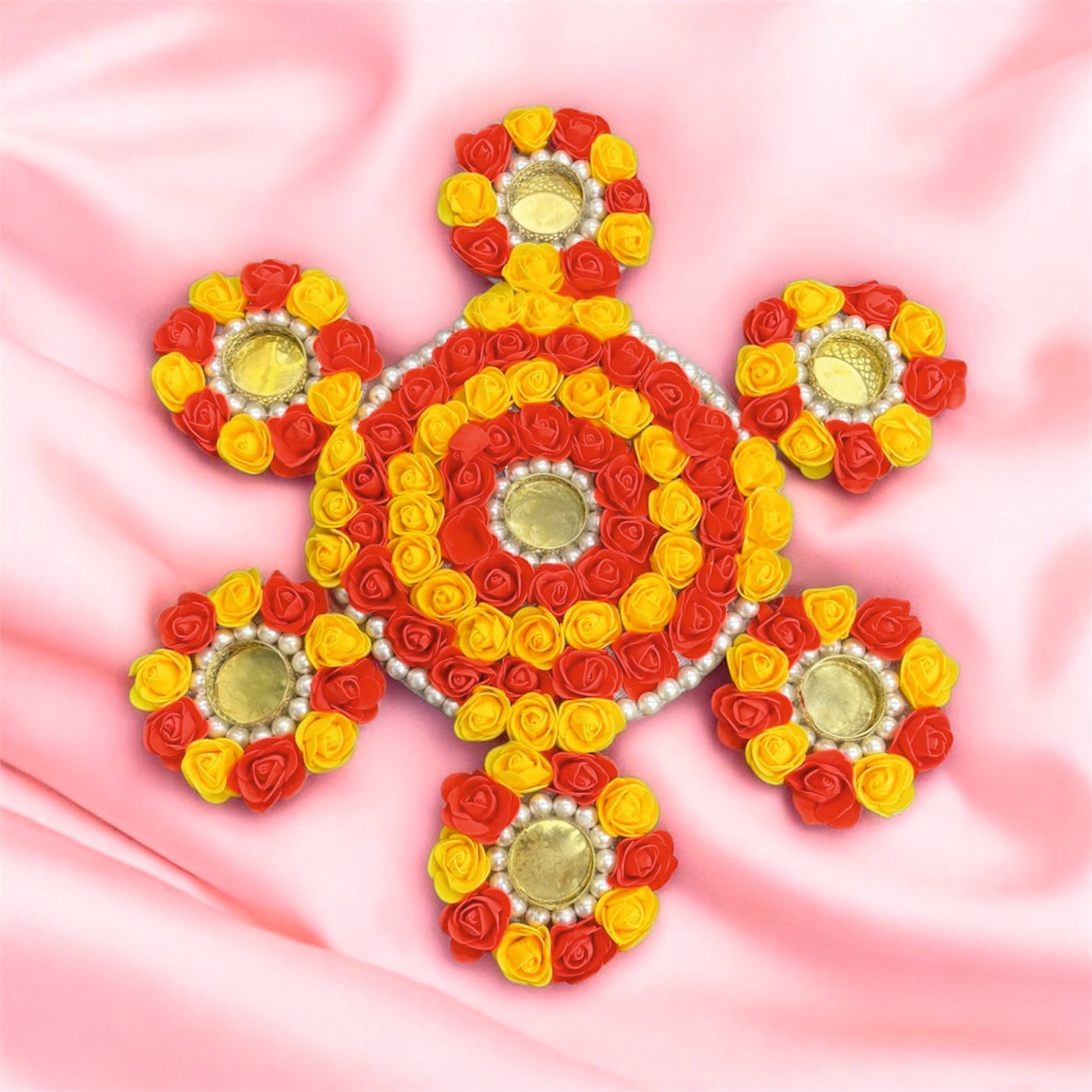 Decorative design made of red, yellow, and gold flowers on a pink background