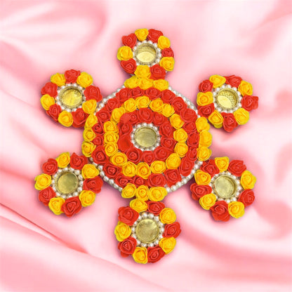 Decorative design made of red, yellow, and gold flowers on a pink background
