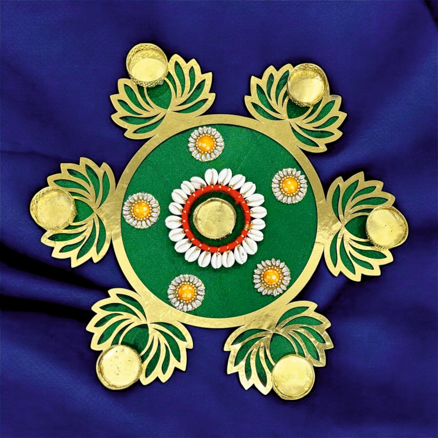 Decorative rangoli design on a blue fabric background