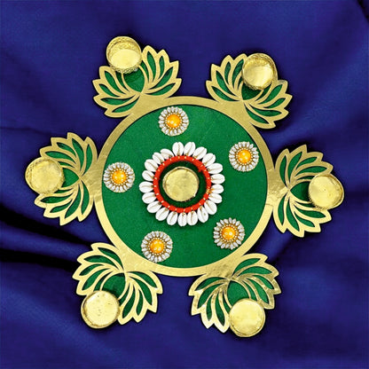 Decorative rangoli design on a blue fabric background
