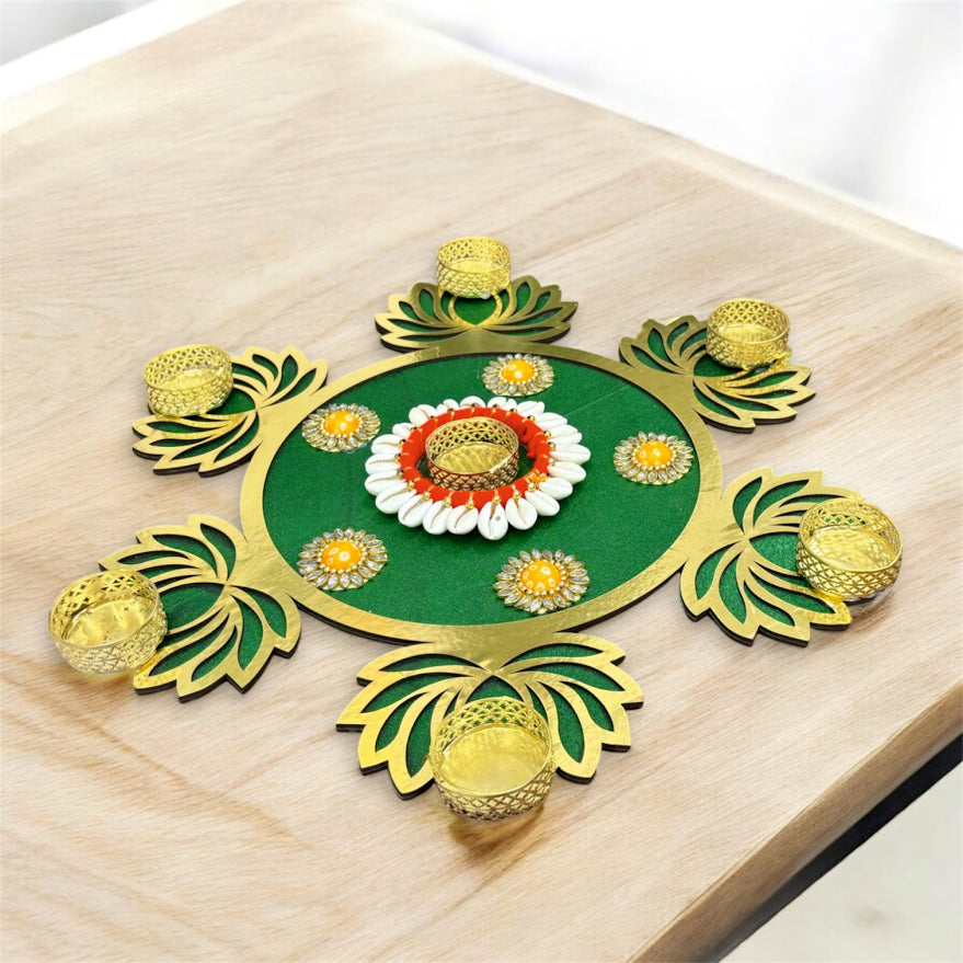 Decorative green and gold rangoli design on a wooden surface