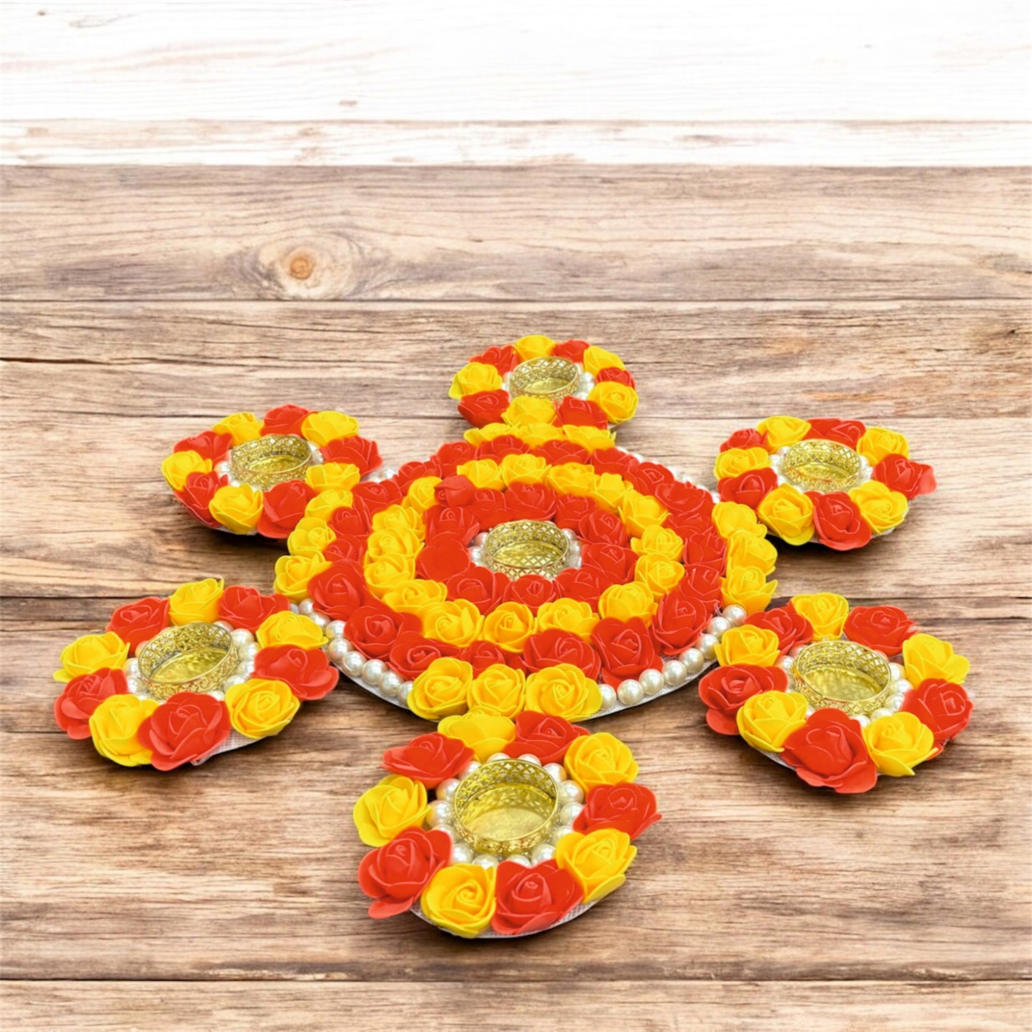 Decorative flower arrangements with candles on a wooden surface