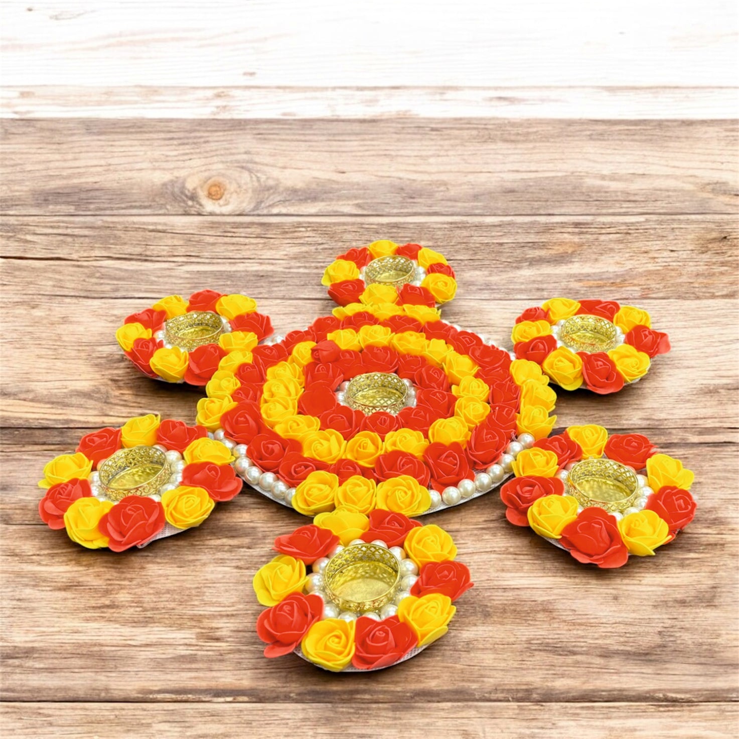 Decorative flower arrangements with candles on a wooden surface