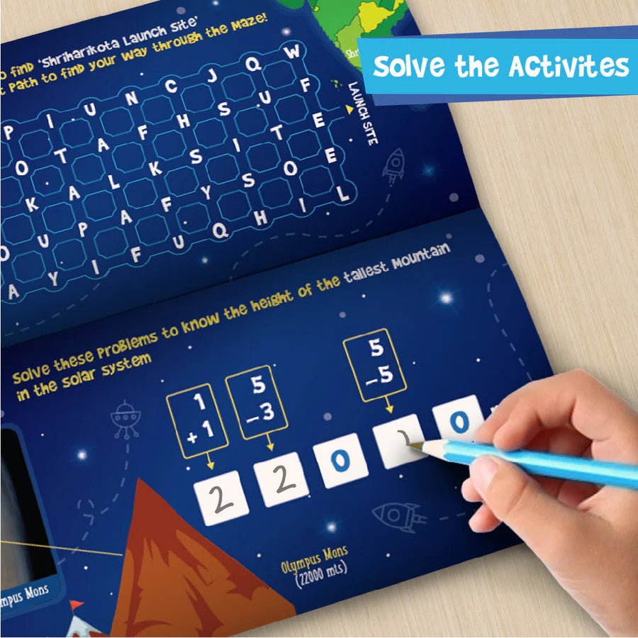Educational activity book with space-themed design, numbers, and letters, being used by a child.