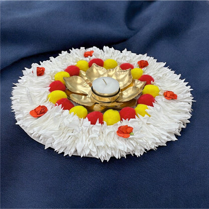 Decorative arrangement with a white base, gold center, and colorful flowers on a blue background