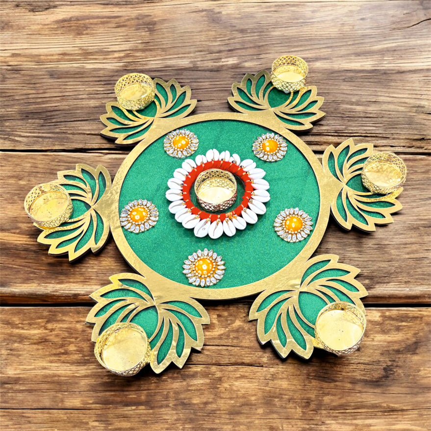 Decorative green and gold plate with floral designs on a wooden surface