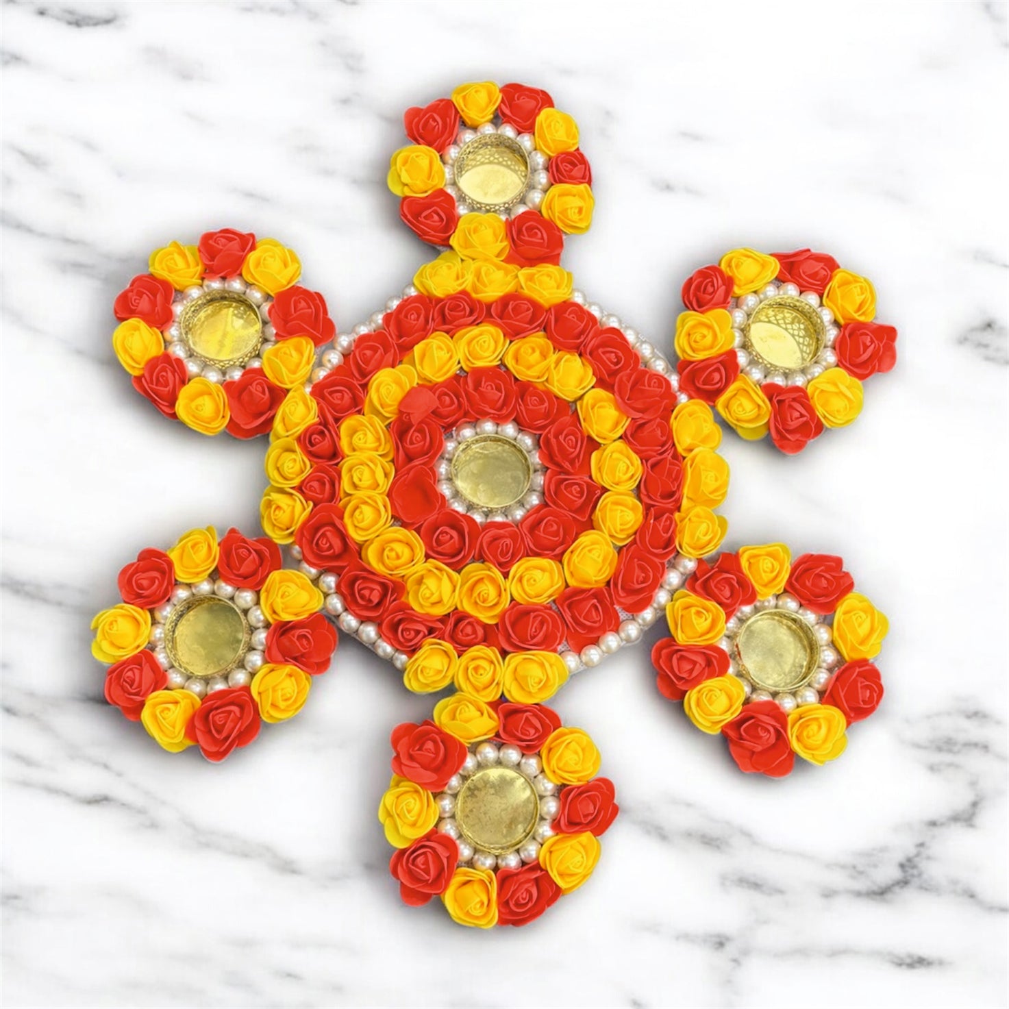 Decorative design made of red, yellow, and gold flowers on a marble background