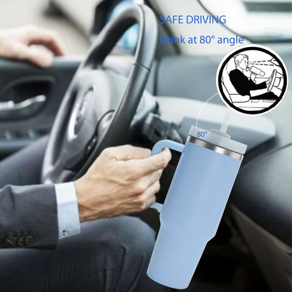 Person holding a blue tumbler with a straw in a car, emphasizing safe driving.