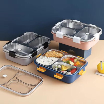 Set of four compartmentalized food containers with lids on a beige surface.