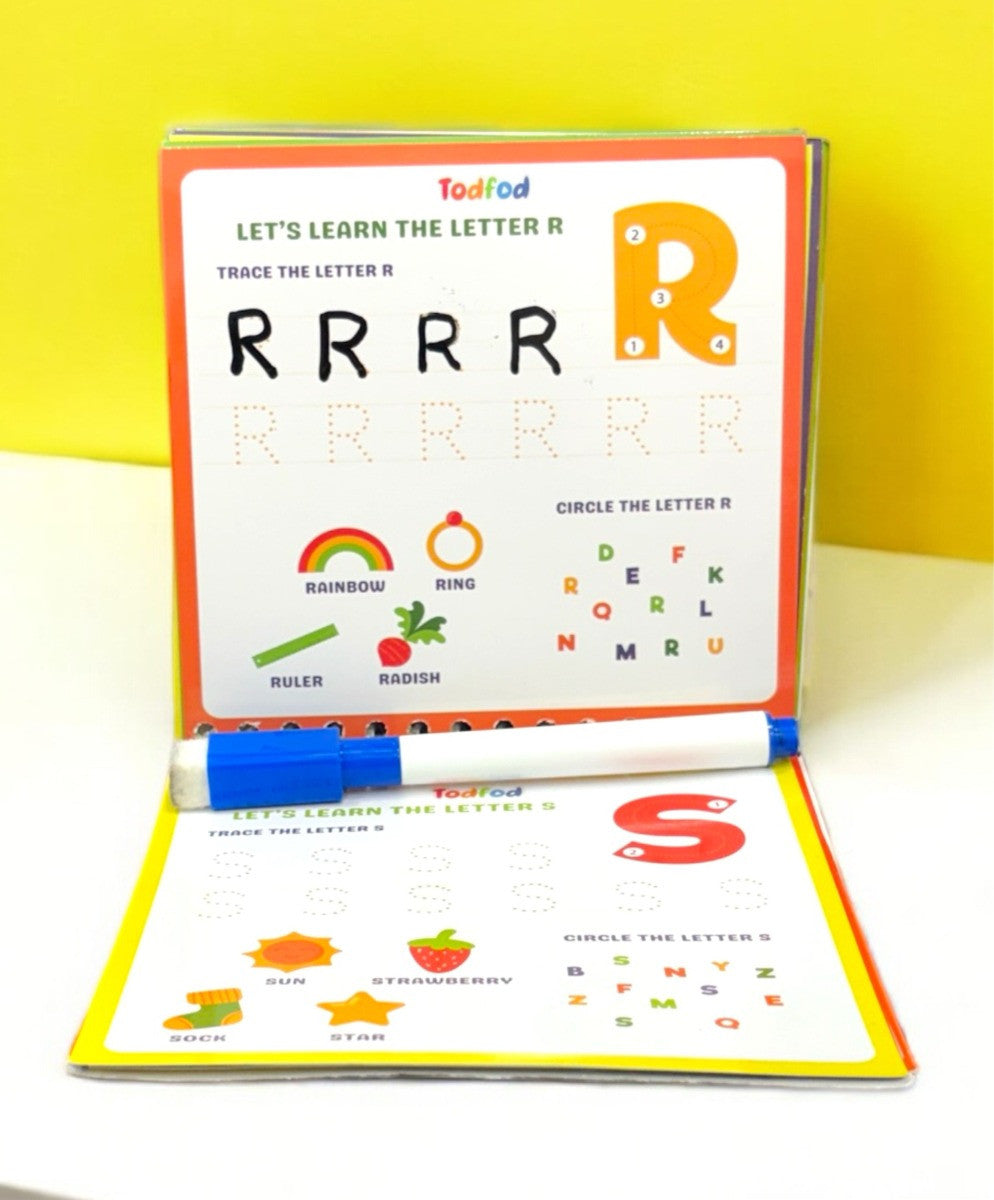 Educational book with letter tracing activity and marker on a yellow background