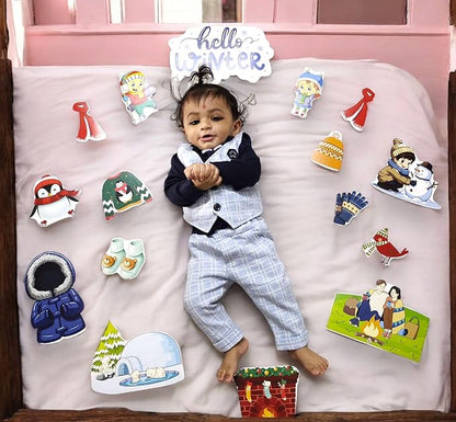 Child in a suit surrounded by winter-themed decorations and stickers on a pink bed.