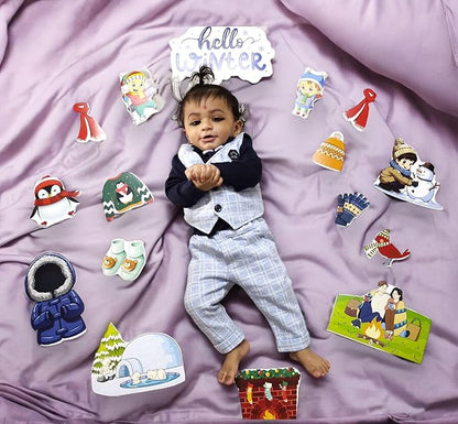 Baby in a suit surrounded by winter-themed illustrations on a purple blanket