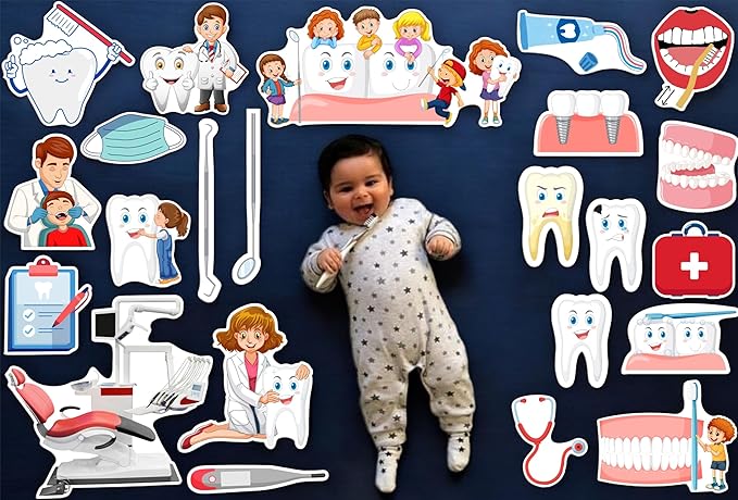 Baby lying on a dark blue surface surrounded by dental-themed illustrations and toys.