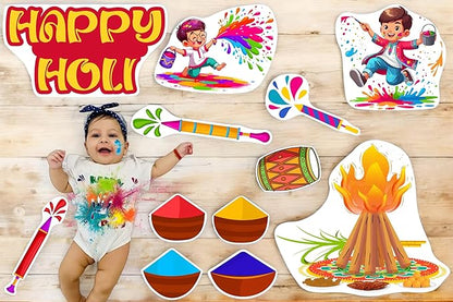 Child with Holi-themed decorations and a baby on a wooden floor