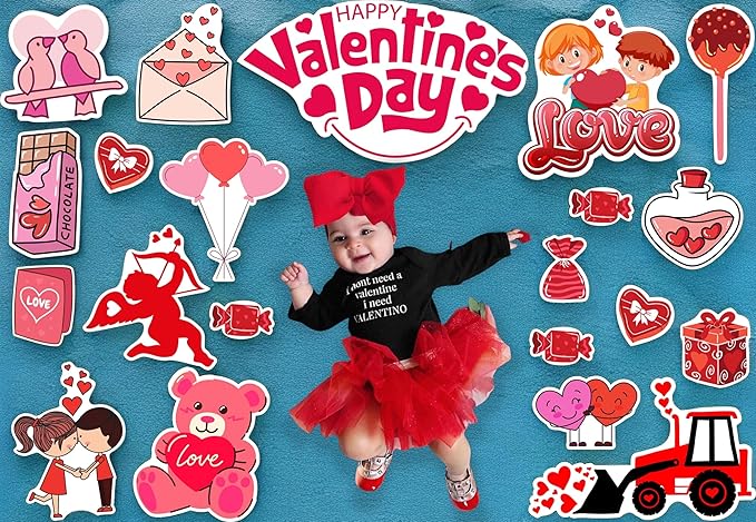 Baby in Valentine's Day-themed outfit surrounded by decorative elements on a blue background