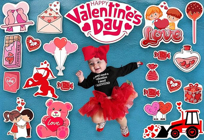 Baby in Valentine's Day-themed outfit surrounded by decorative elements on a blue background