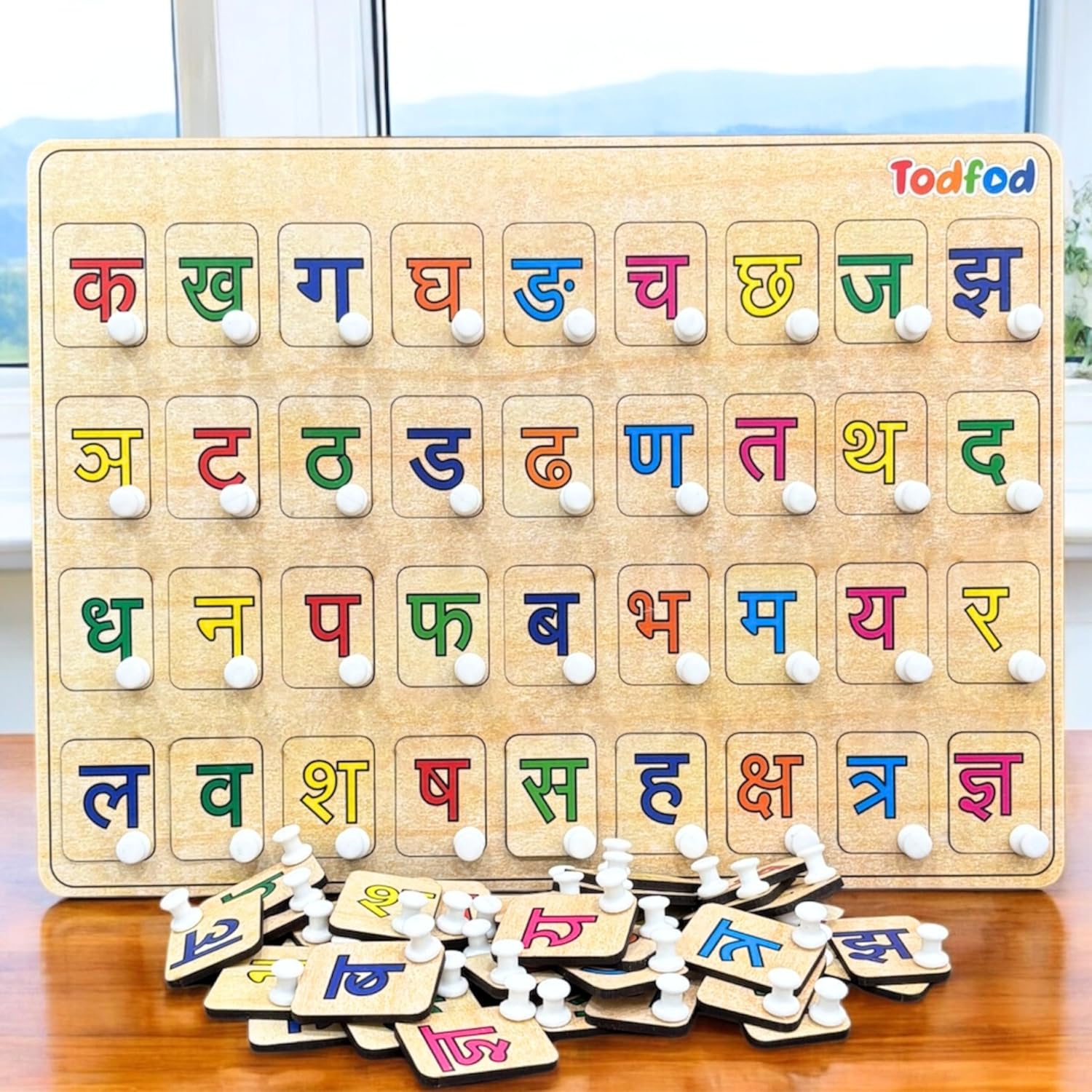 Wooden Hindi alphabet learning board with magnetic letters on a wooden surface.