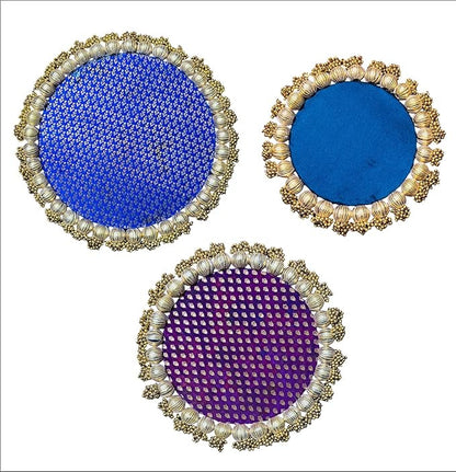 Three circular coasters with decorative frames on a white background