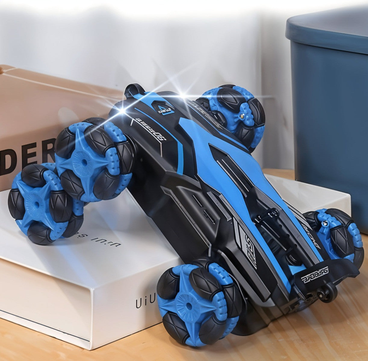 Black and blue handheld massager on a wooden surface with a blurred background