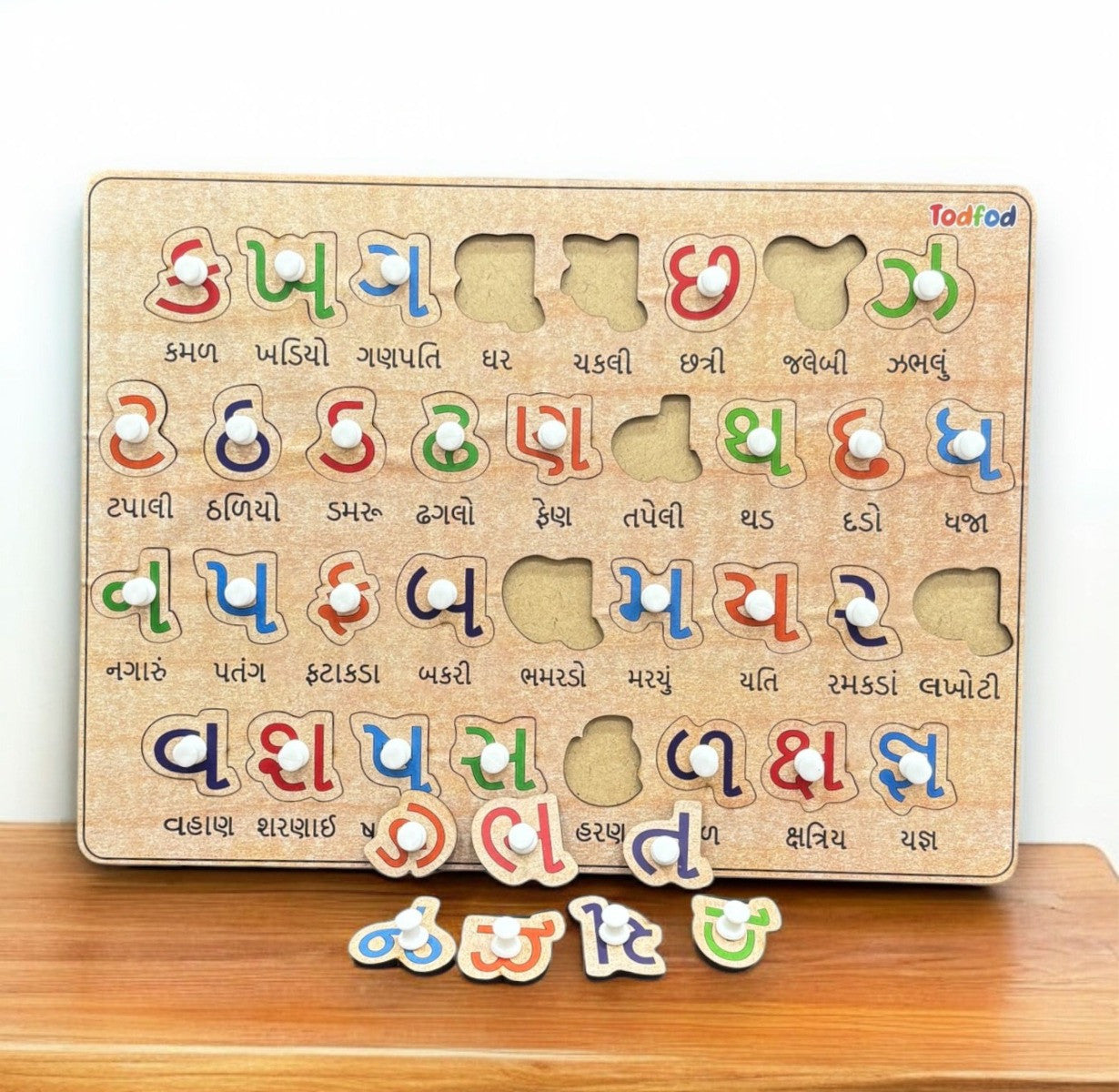 Wooden puzzle with colorful letters on a wooden surface