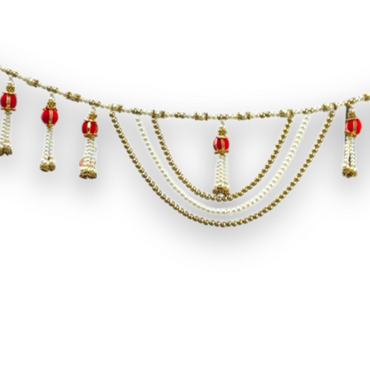 Decorative garland with red balls and gold chains on a white background