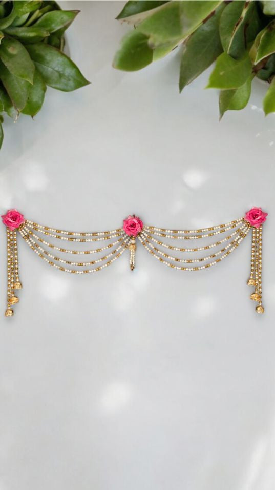 Decorative headband with pink flowers and gold beads on a white background