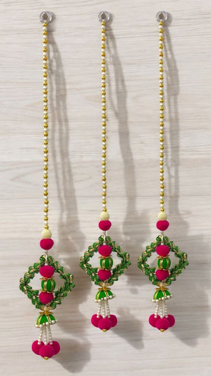 Pair of earrings with pink and green beads on a white background