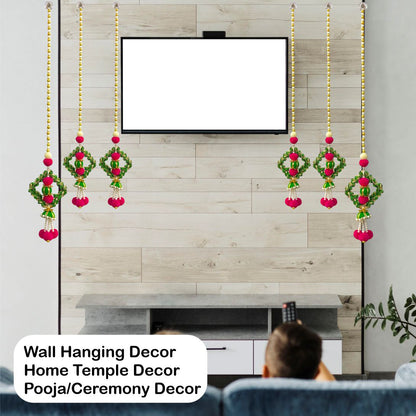 Wall hanging decor with red and green elements in front of a television.